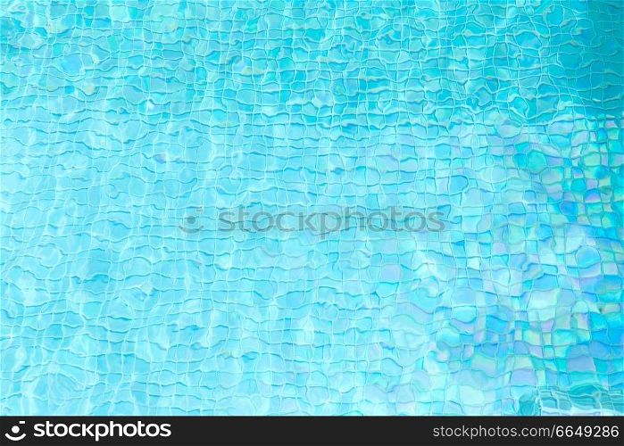 swimming and background concept - turquoise water in tiled pool. turquoise water in tiled swimming pool