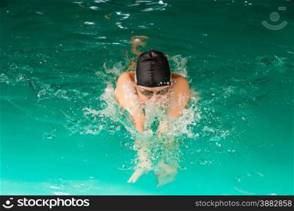 Swimming. Competition and recreation. Woman swimmer breathing. Poolside.