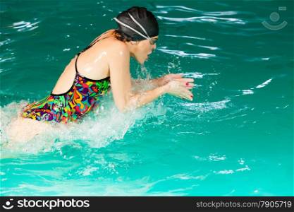 Swimming. Competition and recreation. Woman swimmer breathing. Poolside.