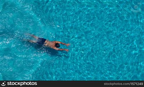 Swimming in hotel pool and blue clear color water in summer and top angle view.