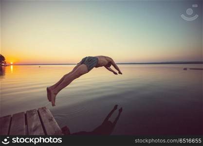 Swimming. Man jumps into the lake