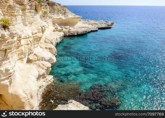 Swimming man turquoise sea background. Relaxed male on his holidays in the sea view from above.