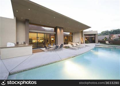 Swimming pool and paved seating area of Palm Springs home exterior