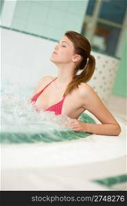 Swimming pool - beautiful woman wearing bikini, relax in bubble bath