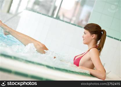 Swimming pool - beautiful woman wearing bikini, relax in bubble bath