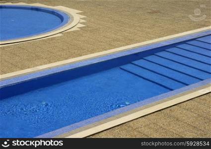 swimming pool blue water in a summer day