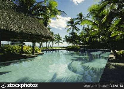 Swimming pool in front of stilt houses, Fiji