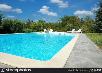 Swimming pool in the garden of an italian luxury villa, sunny day