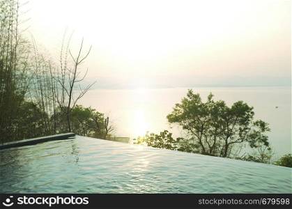 Swimming pool terrace and beautiful nature view ,sunset on Khuean Srinagarindra National Park at Kanchanaburi , Thailand and sky for travel in holiday relax time