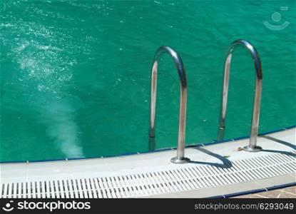 Swimming pool with stair and green relaxing water