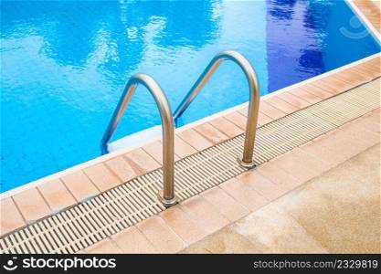 Swimming pool with stair at hotel.