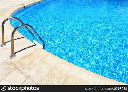 Swimming pool with stair at hotel close up