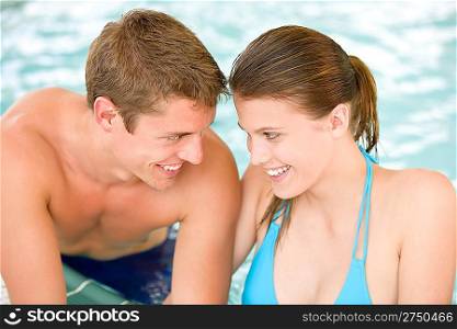 Swimming pool - young loving couple have fun on honeymoon