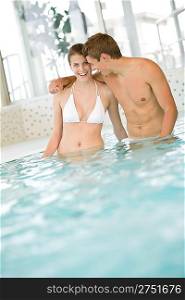 Swimming pool - young sportive couple have fun in water