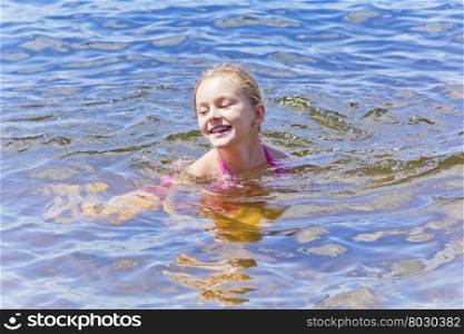 Swimming smiling cute girl seven years old