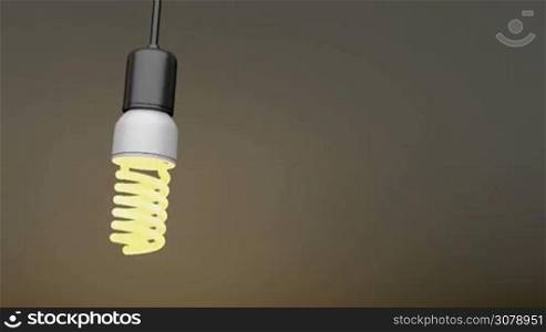 Swinging light bulb in the dark room
