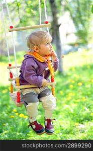 Swinging little girl in park