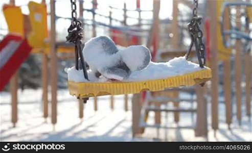 swings on the playground in winter