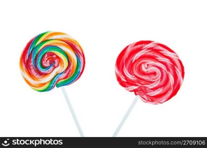 Swirled and colorful candy lollipops on white background.