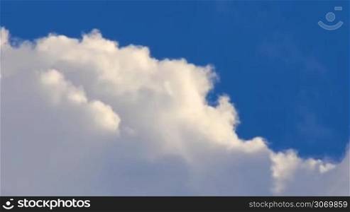 swirling white clouds on a background of deep blue sky