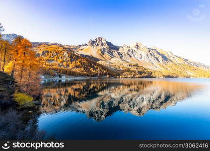 Swiss Alpine landscape with an Engadine lake and mirrored mountain