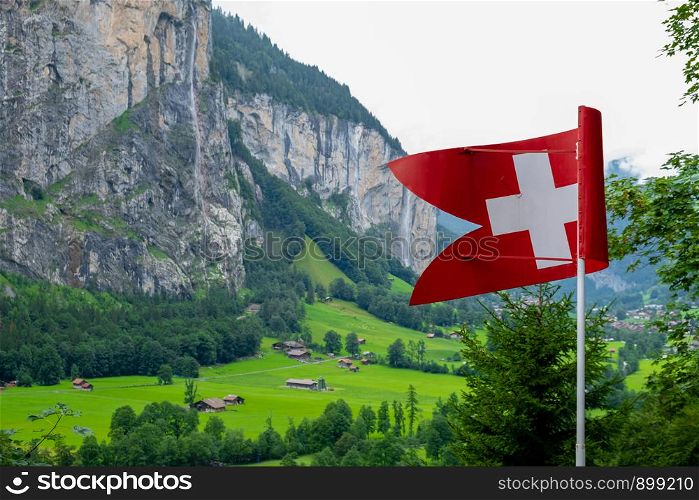 Swiss flag and in the background its typical mountains