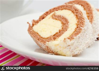 Swiss Sponge Roll With Cream on White Plate
