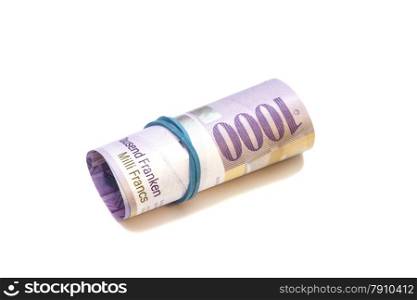 Swiss thousand francs in a roll on white background