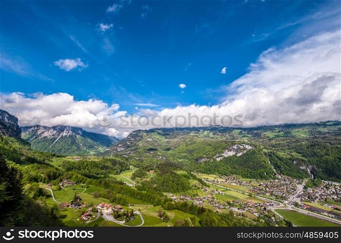 Swiss village in valley under low clouds near Reichenbach, Switzerland