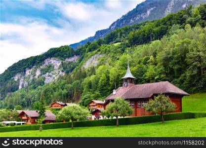 Swiss village Iseltwald with traditional wood church on the southern shore of Lake Brienz, Switzerland. Swiss village Iseltwald, Switzerland