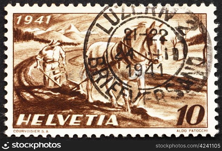 SWITZERLAND - CIRCA 1941: a stamp printed in the Switzerland shows Farmer Plowing, National Agriculture Plan of 1941, circa 1941