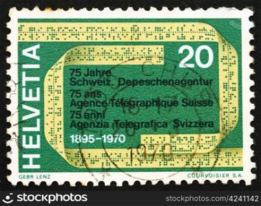 SWITZERLAND - CIRCA 1970: a stamp printed in the Switzerland shows Telex Tape, 75th Anniversary of the Swiss Telegraph Agency, circa 1970