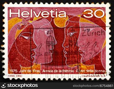 SWITZERLAND - CIRCA 1975: a stamp printed in the Switzerland shows Women of Four Races, International Women&rsquo;s Year 1975, circa 1975