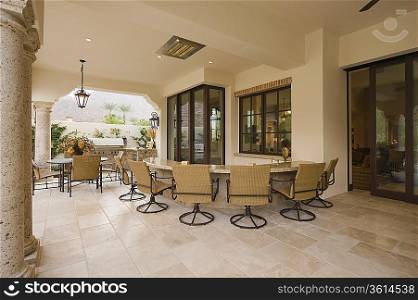 Swivel armchairs at bar area of outdoor room Palm Springs home
