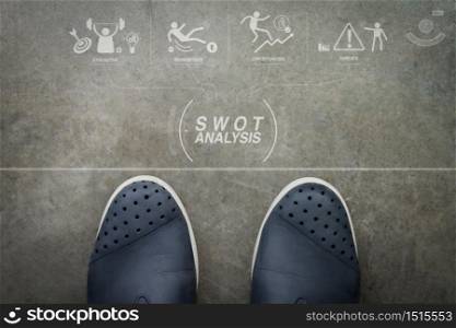 SWOT Analysis virtual diagram with Strengths, weaknesses, threats and opportunities of company.Hand drawn DESIGN design word on front of business man feet as concept