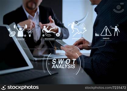 SWOT Analysis virtual diagram with Strengths, weaknesses, threats and opportunities of company.co working team meeting concept,businessman using smart phone and digital tablet and laptop computer.