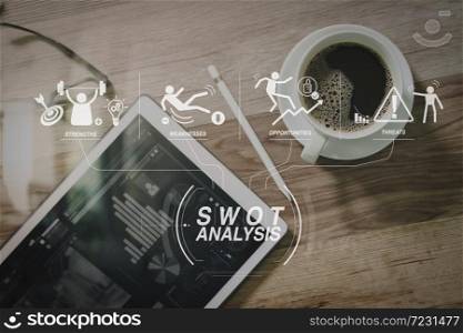SWOT Analysis virtual diagram with Strengths, weaknesses, threats and opportunities of company.Coffee cup and Digital table dock smart keyboard,eyeglasses,stylus pen on wooden table,filter effect,icons screen