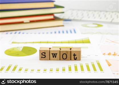 SWOT word on rubber stamps place on graph analysis of business reports concept to evaluate and planning projects