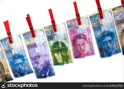 symbol for money laundering by swiss franc on clothesline