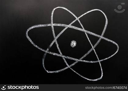 symbol of atom, also nuclear energy, plant, reactor, research or uranium, sketched with white chalk on a blackboard