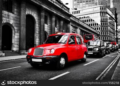 Symbol of London, the UK. Taxi cab known as hackney carriage.. Black and white with red. Iconic English transportation, red buses in the background. Symbol of London, the UK. Taxi cab known as hackney carriage.