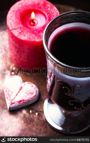 Symbol Valentines Day. Glass of wine, candle and symbolic hearts.Valentines Day