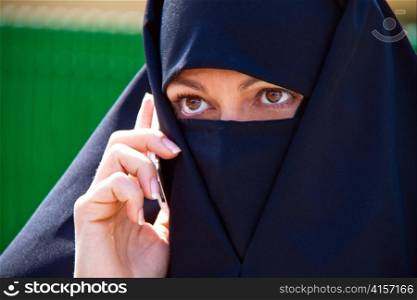 symbolfoto islam. muslim burqa is with obscured.