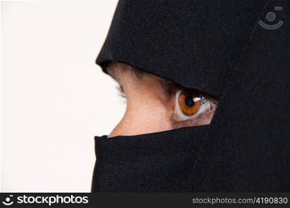 symbolfoto islam. muslim burqa is with obscured.
