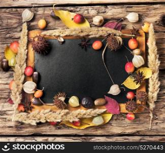 symbolic autumn background. autumn foliage, apples, walnut, acorns and cinnamon on a retro background