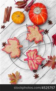Symbolic autumn cookies. Cookies in shape of maple autumn leaf in autumn still life
