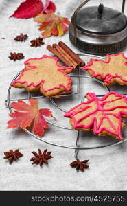 Symbolic autumn cookies. Cookies in the shape of maple autumn leaf in the autumn still life