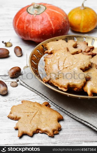 Symbolic autumn cookies. Cookies in the shape of maple autumn leaf in the autumn decoration