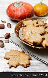 Symbolic autumn cookies. Cookies in the shape of maple autumn leaf in the autumn decoration