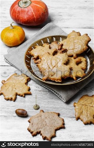 Symbolic autumn cookies. Cookies in the shape of maple autumn leaf in the autumn decoration